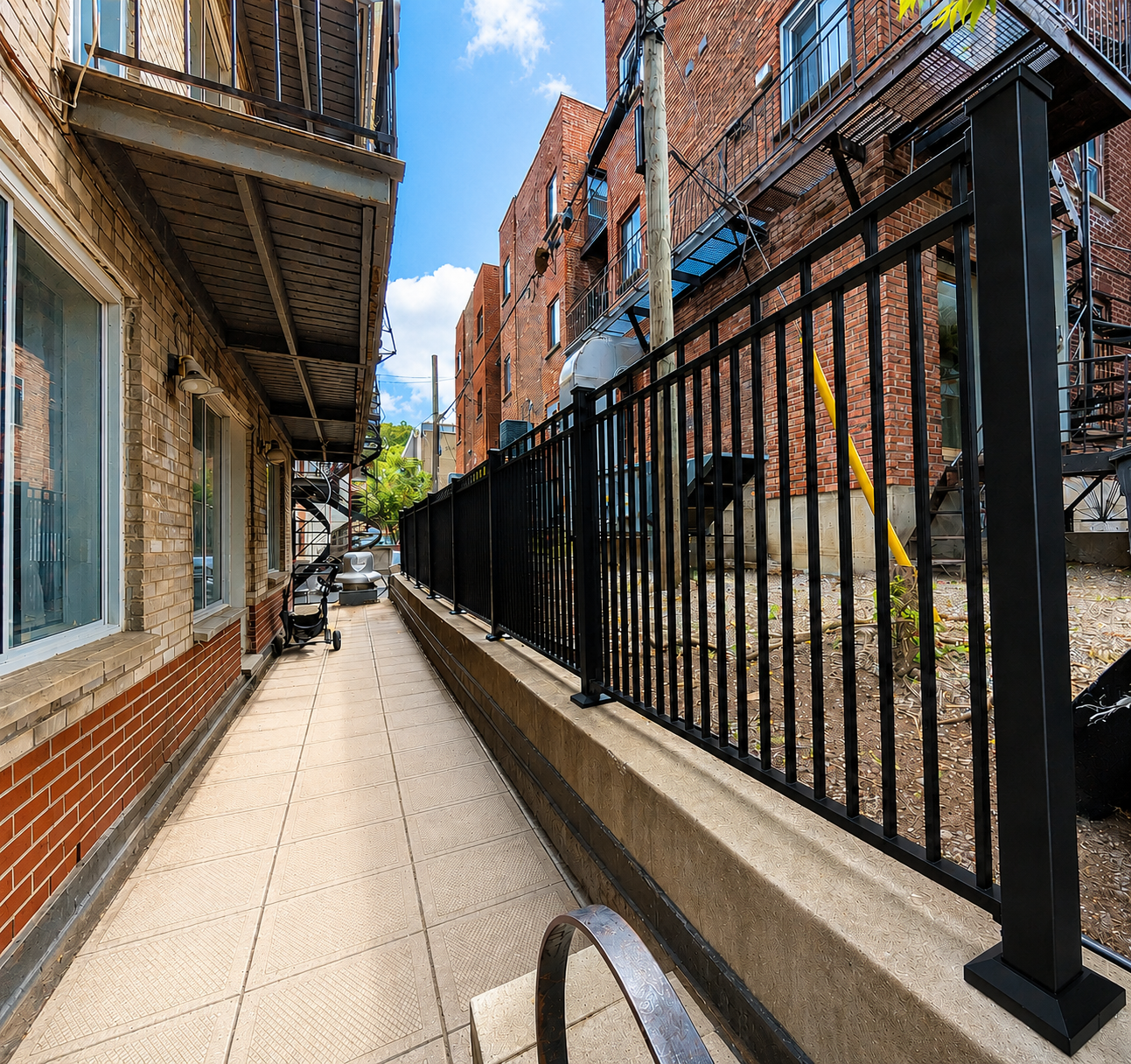 Black aluminum railing fence along an urban walkway