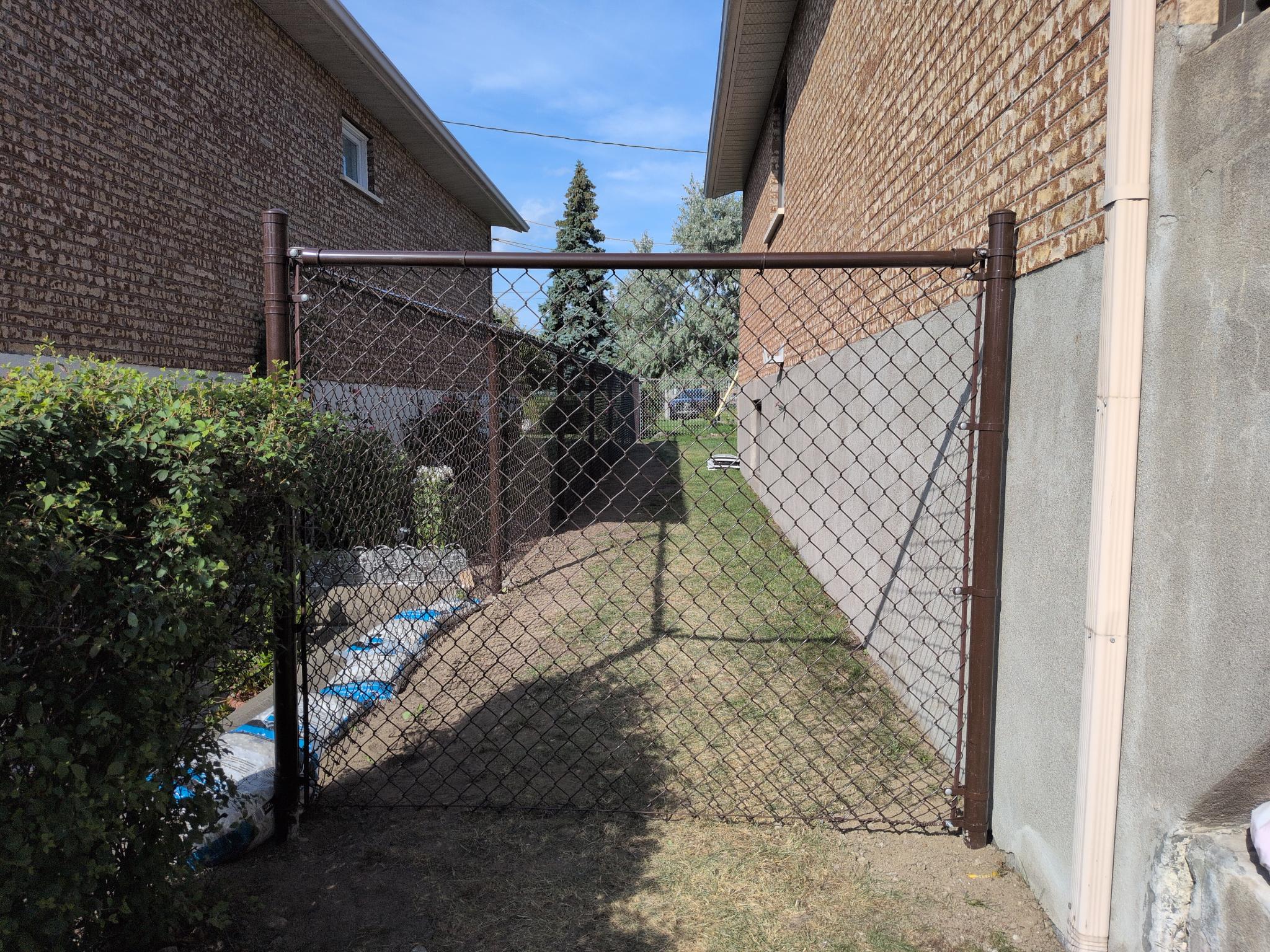 Chain-link fence with gate along a side yard