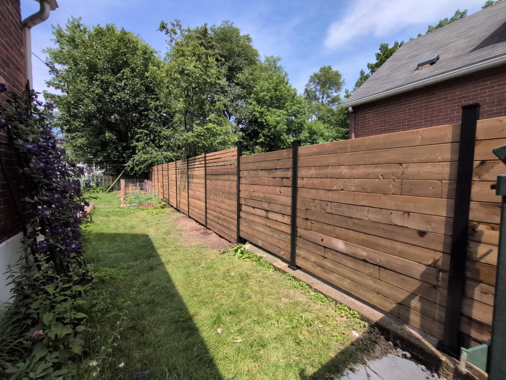 Horizontal wood privacy fence along a side yard